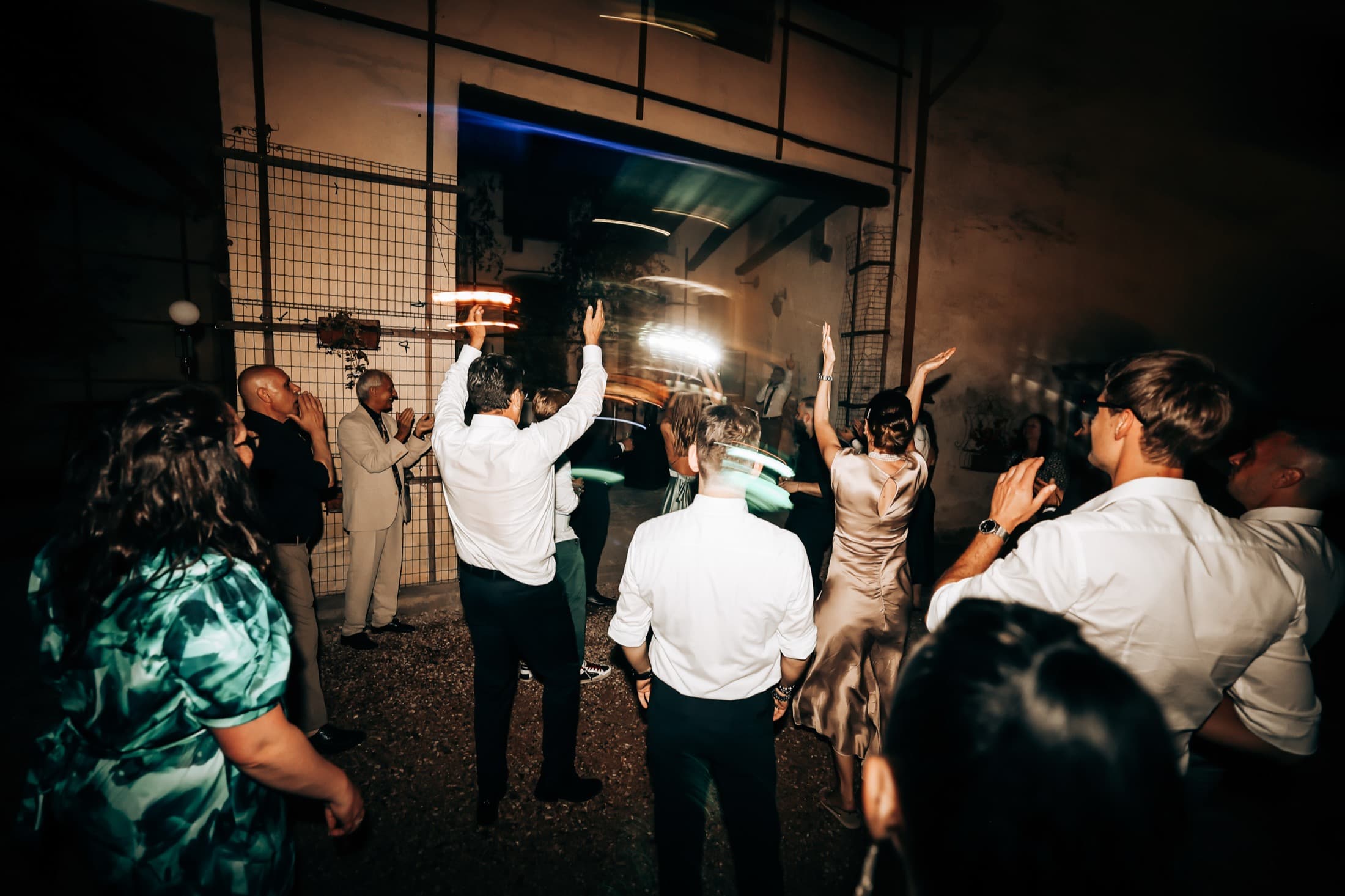 Guests cheering on the dance floor at night