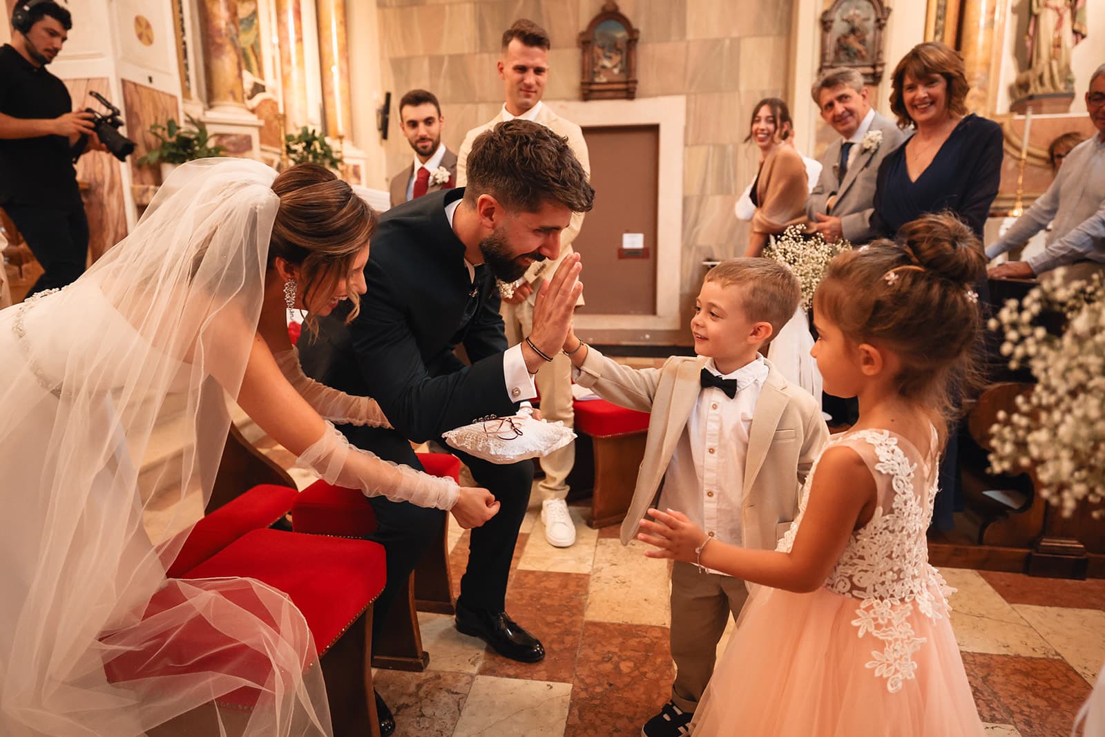 Ring bearers bringing the rings to the couple