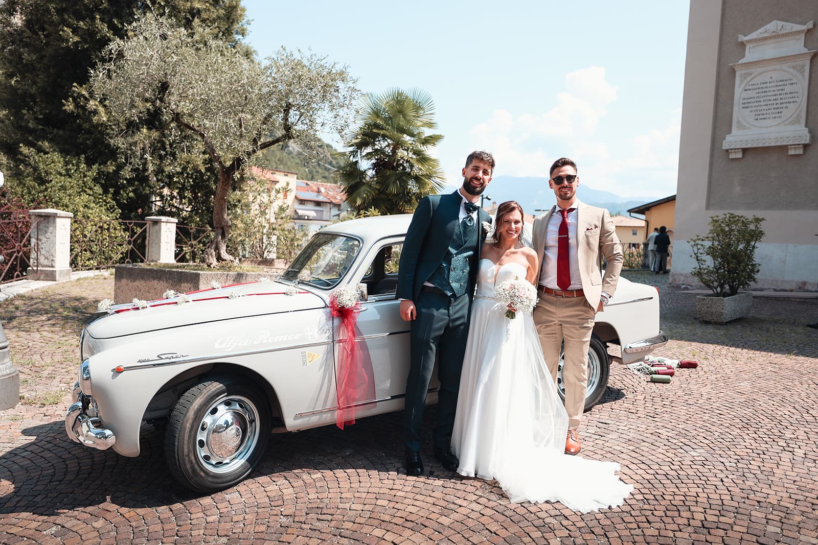 Newlyweds with a vintage car against the mountains